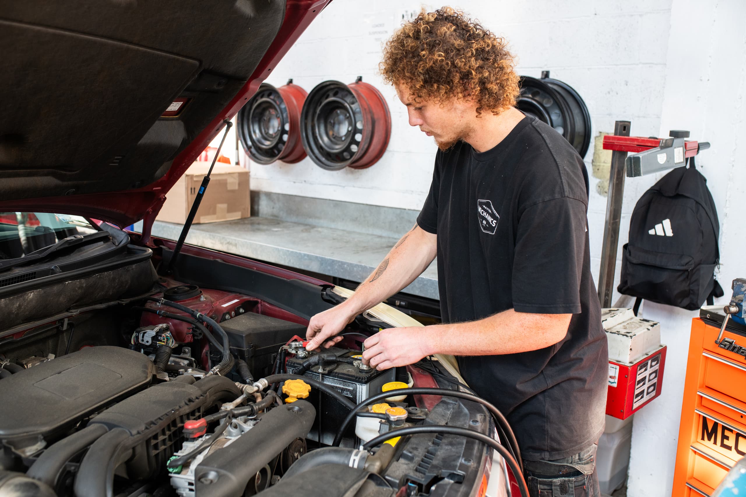 Technician servicing a car at Master Mechanics